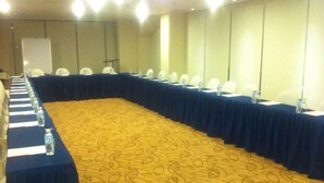 A conference room with a long table, chairs, and a carpeted floor. - Metro Hotel (Kuala Lumpur)