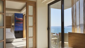 A hotel room with a balcony, a bed, a desk, and a view of the sea. - Esperos Mare Resort & Spa (Rhodes)