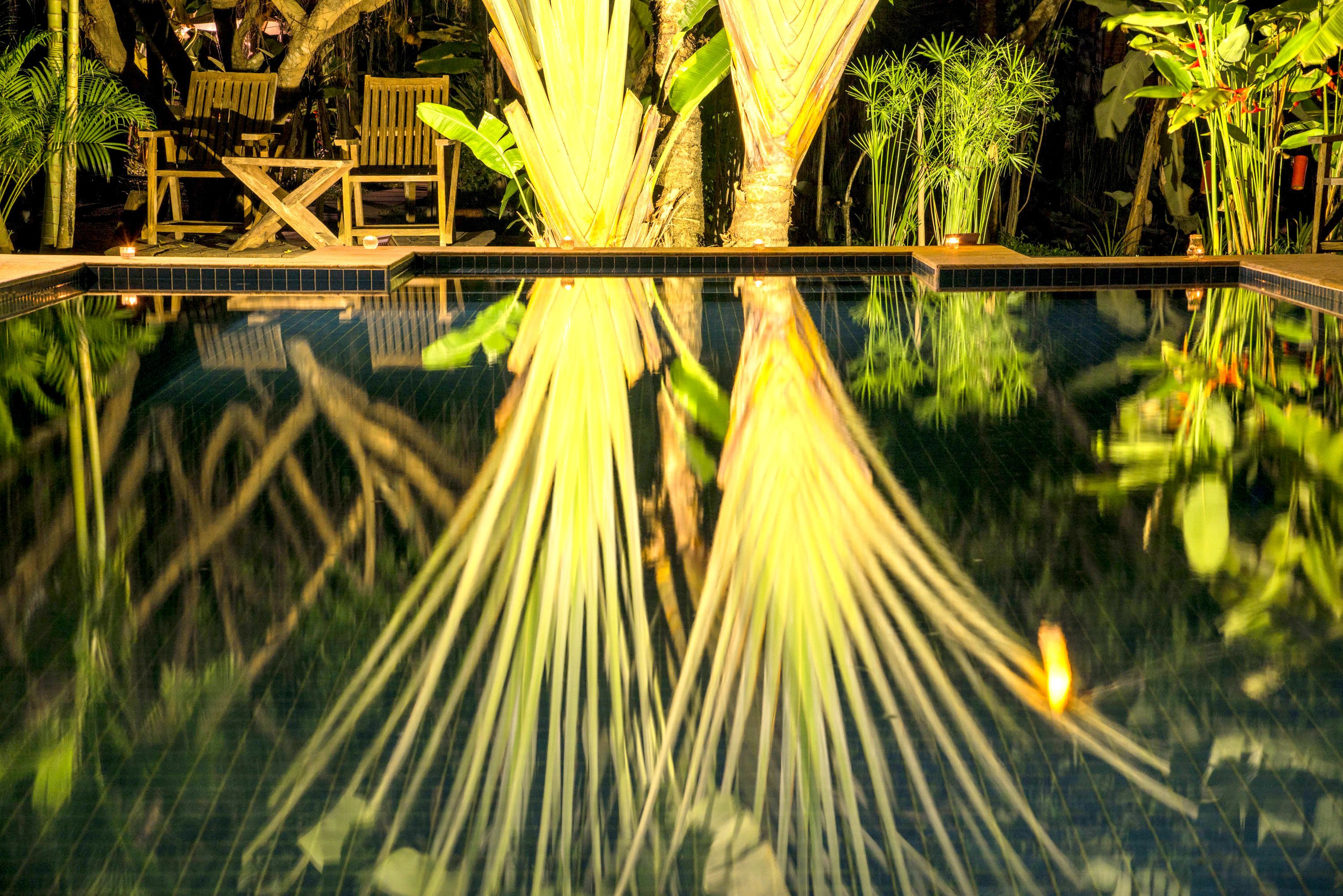 outdoor pool, a natural pool, pool umbrellas, pool loungers