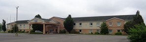 Guests enter through a covered walkway to the main entrance of this two-story building.