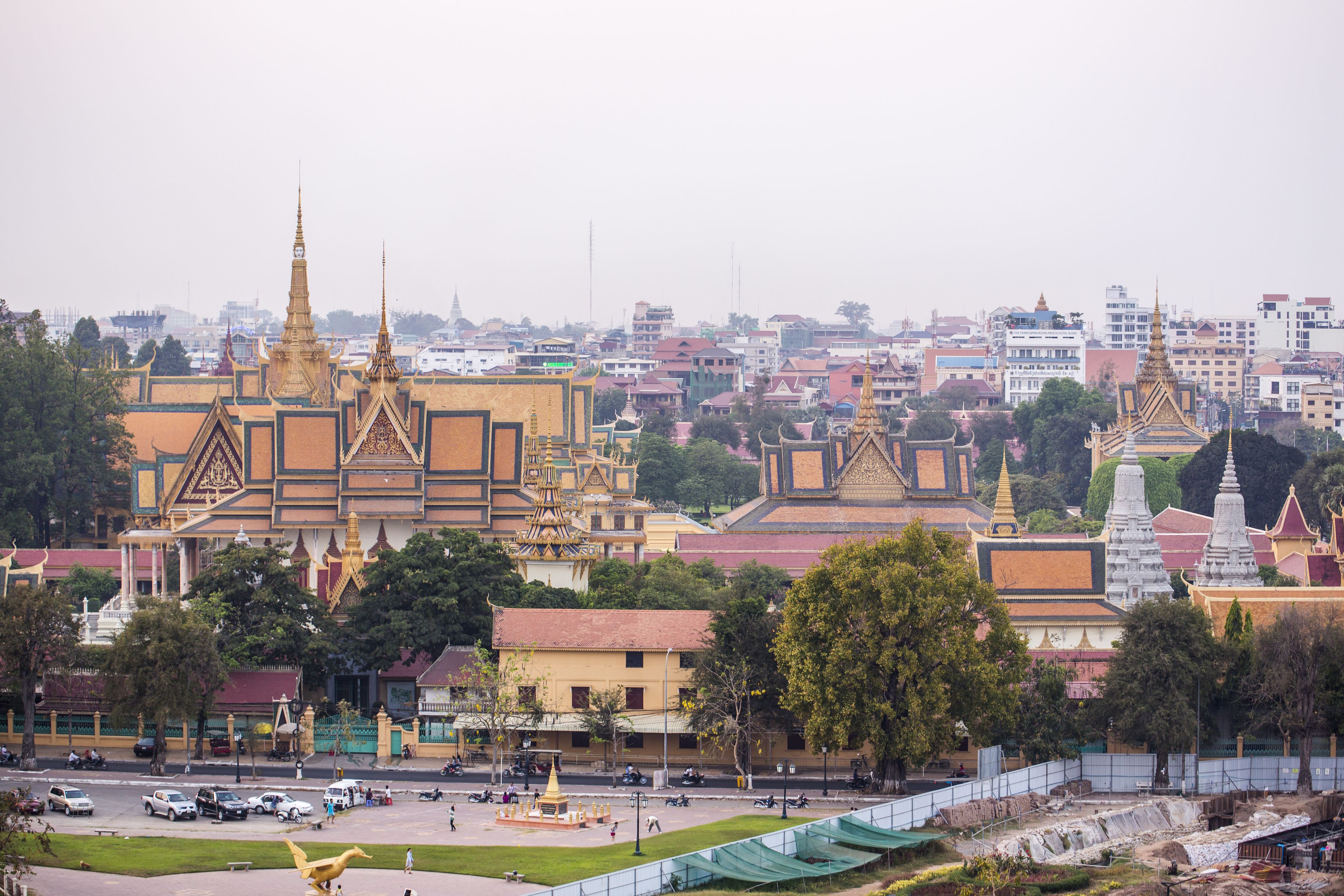 A large temple complex with multiple golden spires and traditional architecture.