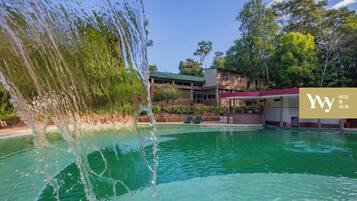Relax by the hotel's indoor pool, featuring a soothing water feature and a beautiful view.