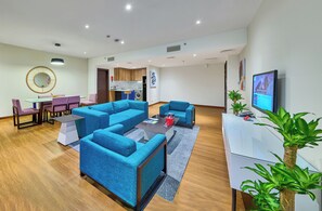 Suite, 2 Bedrooms, Balcony, City View | Living area | Flat-screen TV