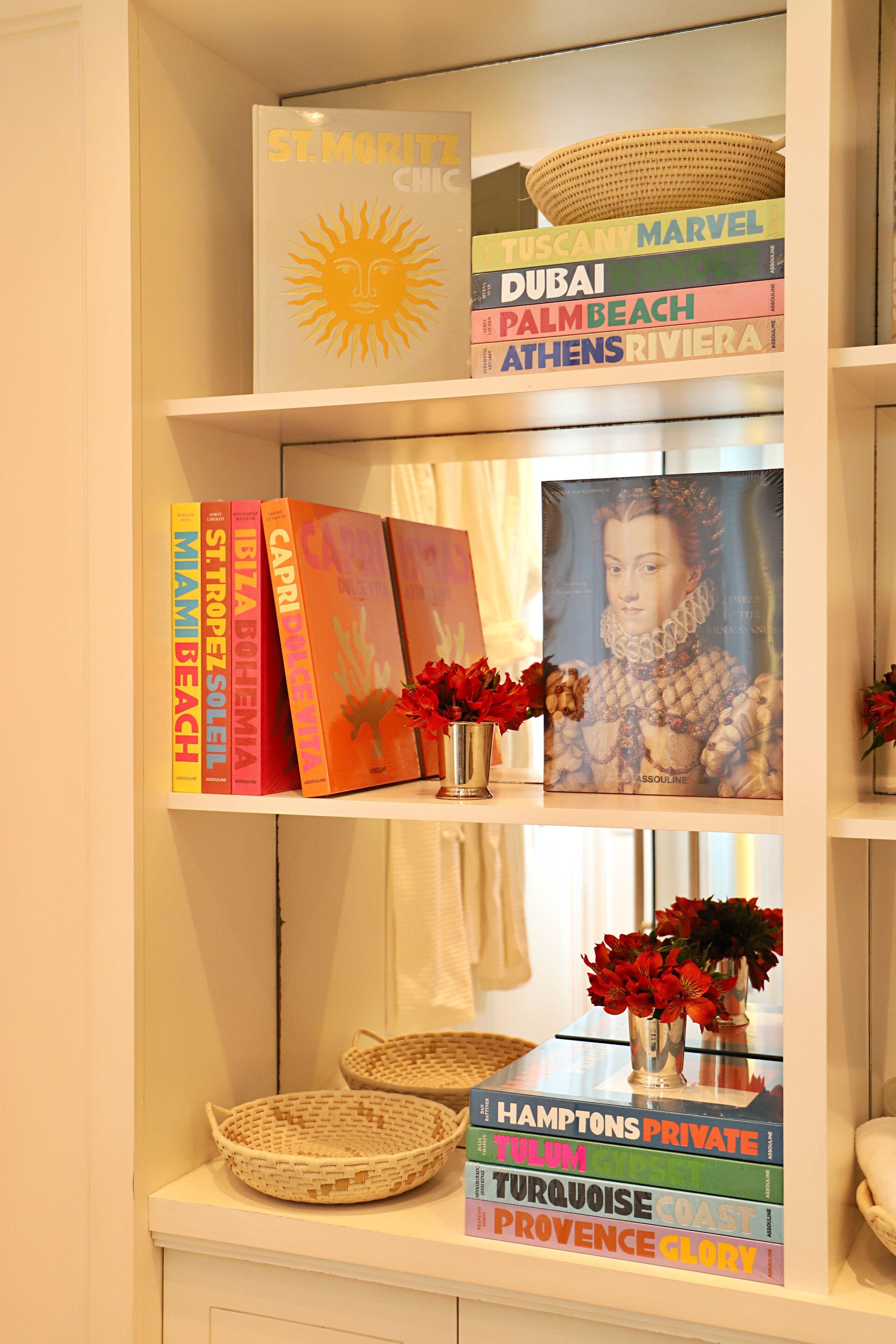A bookshelf with travel books and decorative items.