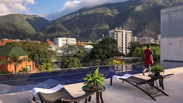 Outdoor pool, open 7:00 AM to 7:00 PM, pool umbrellas, sun loungers