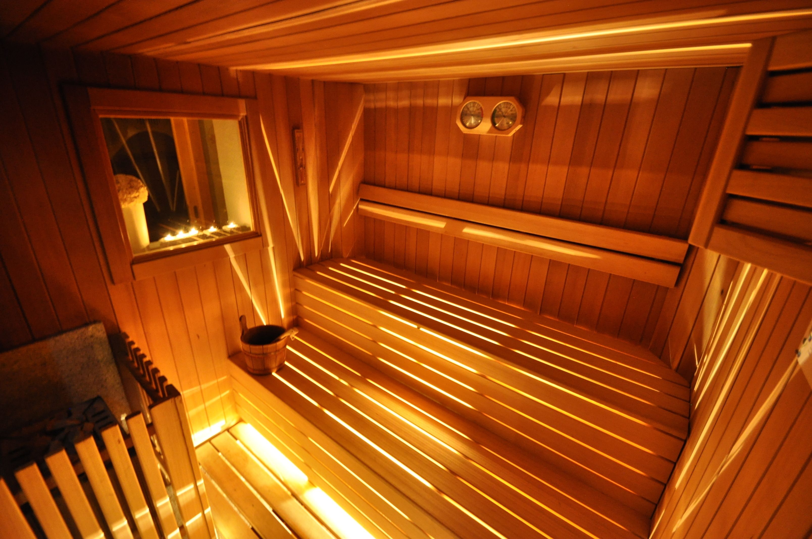 A sauna with wooden benches and a window.