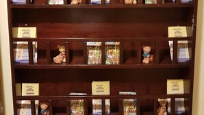 A wooden display shelf with multiple compartments containing books and small teddy bears. - Sun Inns Hotel Bandar Puchong Utama (Puchong)