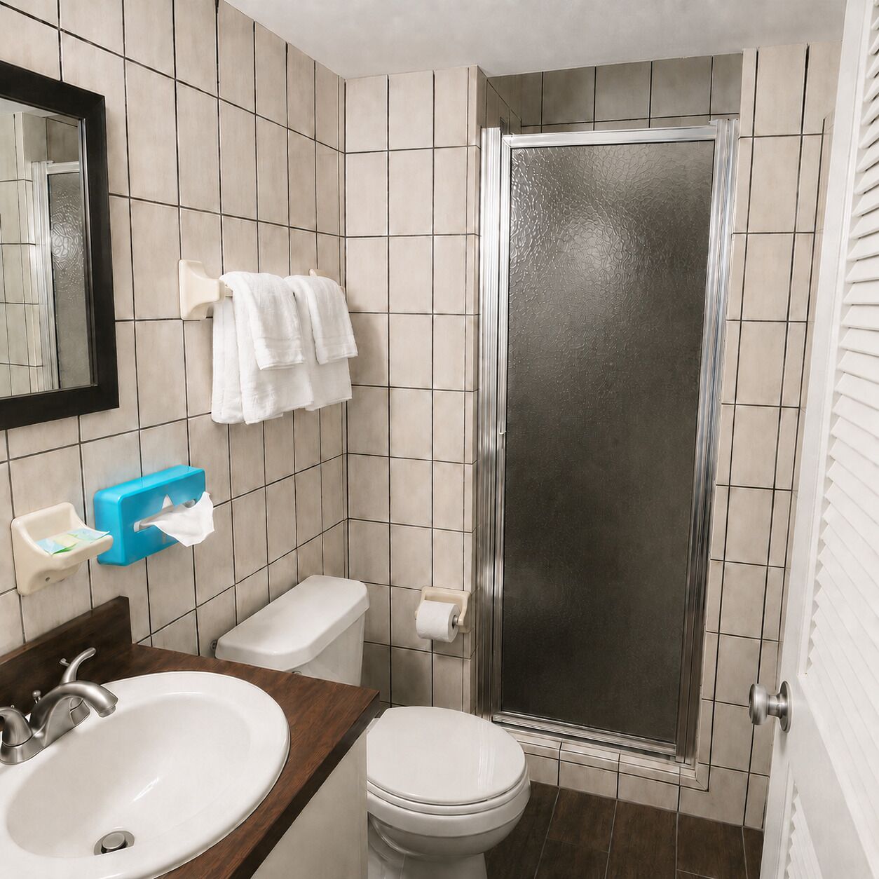 A bathroom with a sink, toilet, and shower.