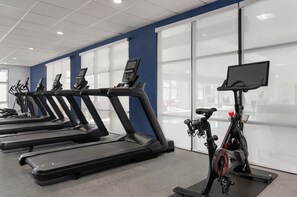 A fitness center with multiple treadmills and an exercise bike. - Hampton Inn Detroit/Southgate (Southgate)