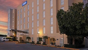 Un hotel amb façana plana, nombroses finestres i un rètol que indica que és un Holiday Inn Express.
