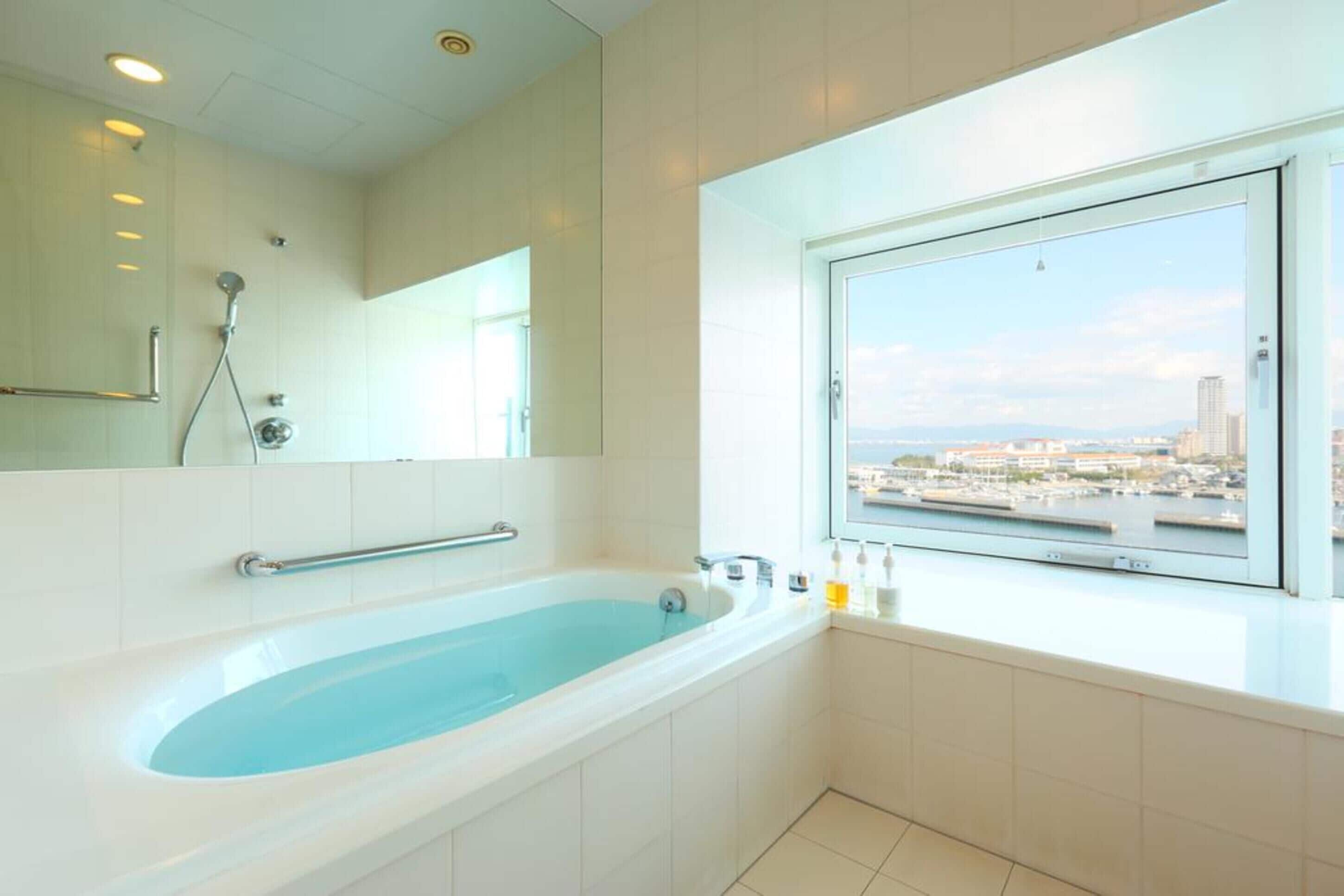 twin room | bathroom | separate bathtub and shower, free toiletries, hair dryer, slippers