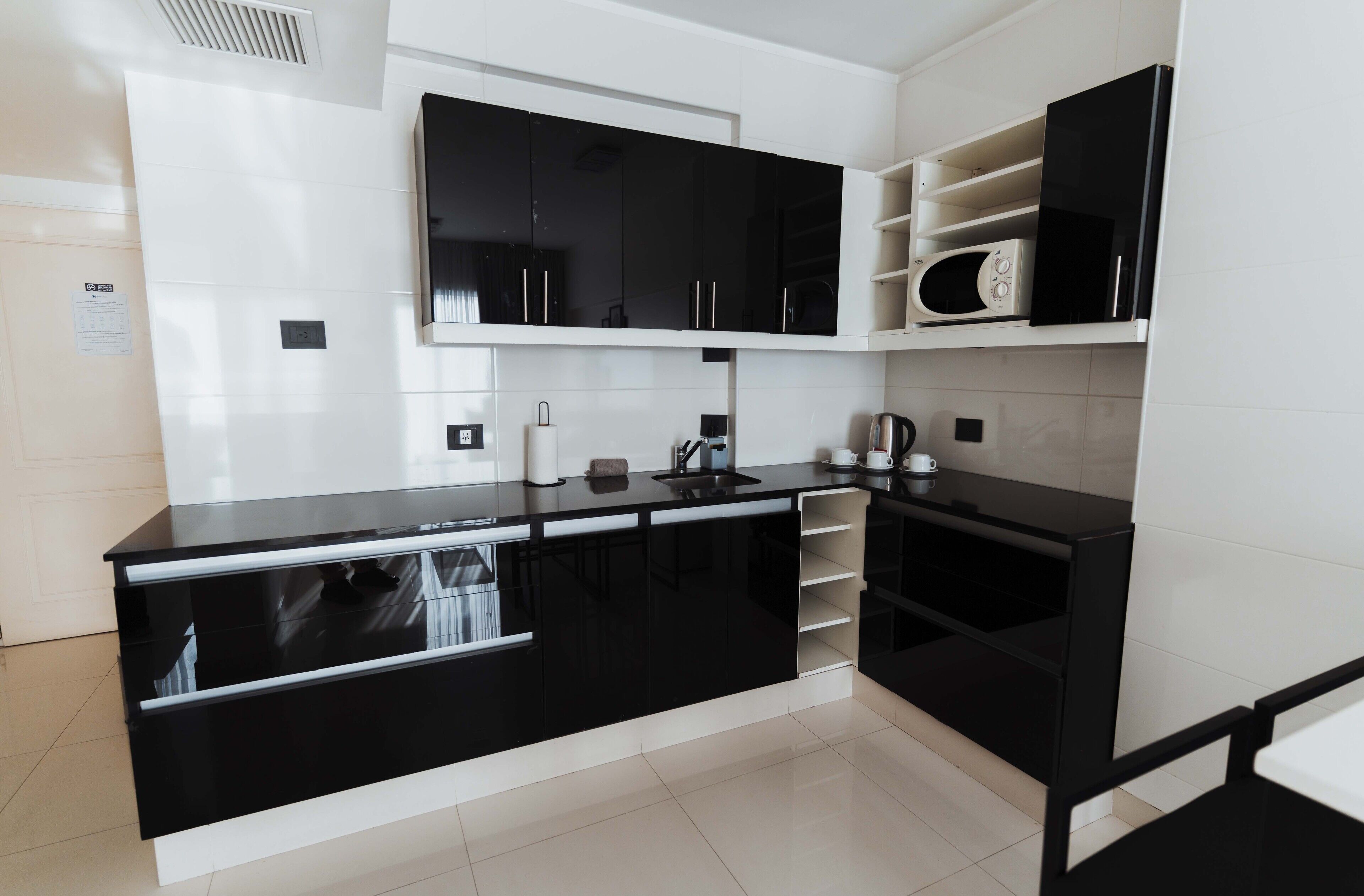 Microwave, cookware/dishes/utensils, cleaning supplies, paper towels