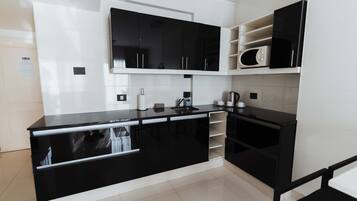 Microwave, cookware/dishes/utensils, cleaning supplies, paper towels