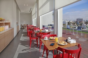 Enjoy a casual dining experience with tables set for a meal, featuring plates, glasses, and cups.