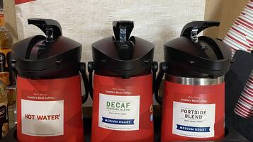 Three coffee dispensers labeled "Seattle's Best Coffee" with "Hot Water," "Decaf Portside Blend," and "Portside Blend" options.