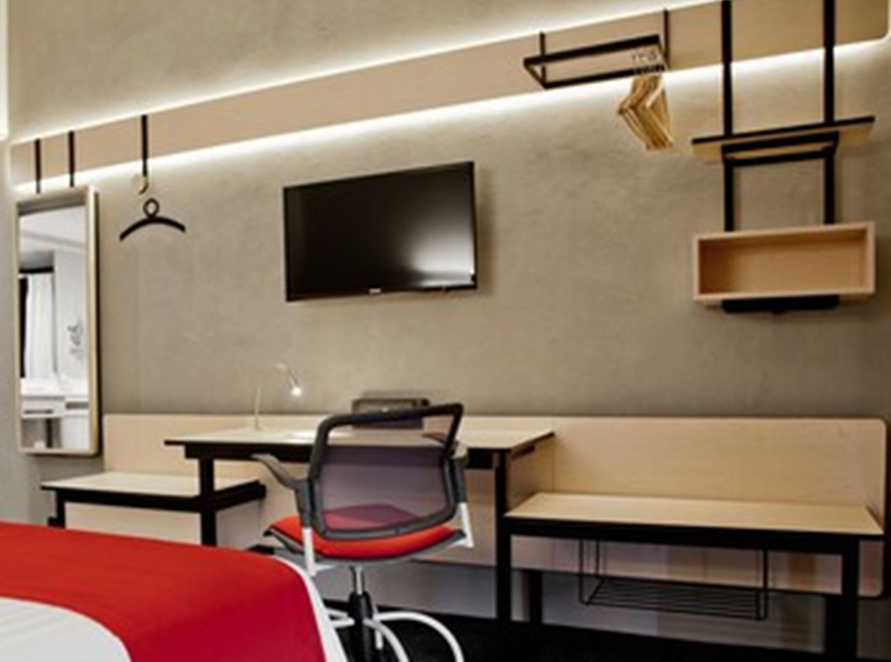 A modern hotel room with a bed, a desk, a chair, a TV, and a bench.