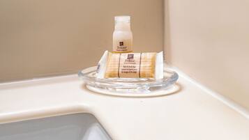 A Prolerta face and body bar soap dispenser on a bathroom sink.