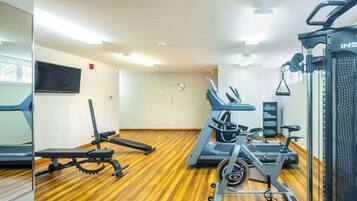 A gym with treadmills, stationary bikes, and weight machines.