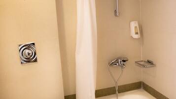 A bathroom with a toilet, a shower, and a bathtub.