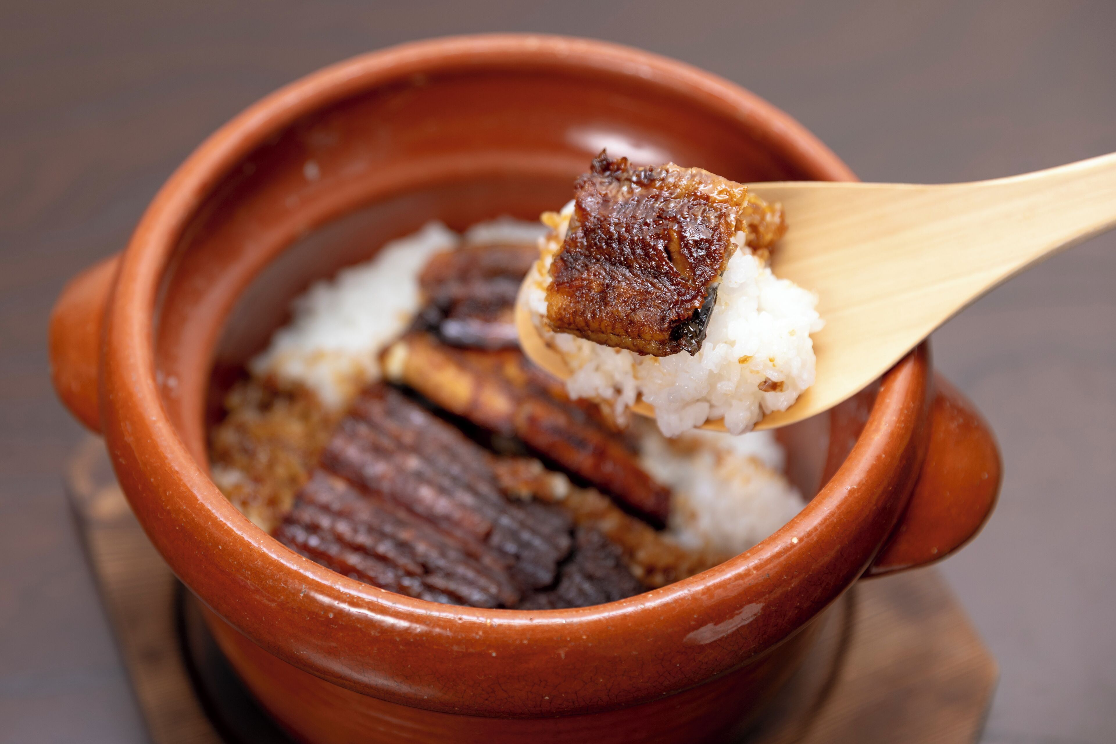 A clay pot containing rice and pieces of meat.