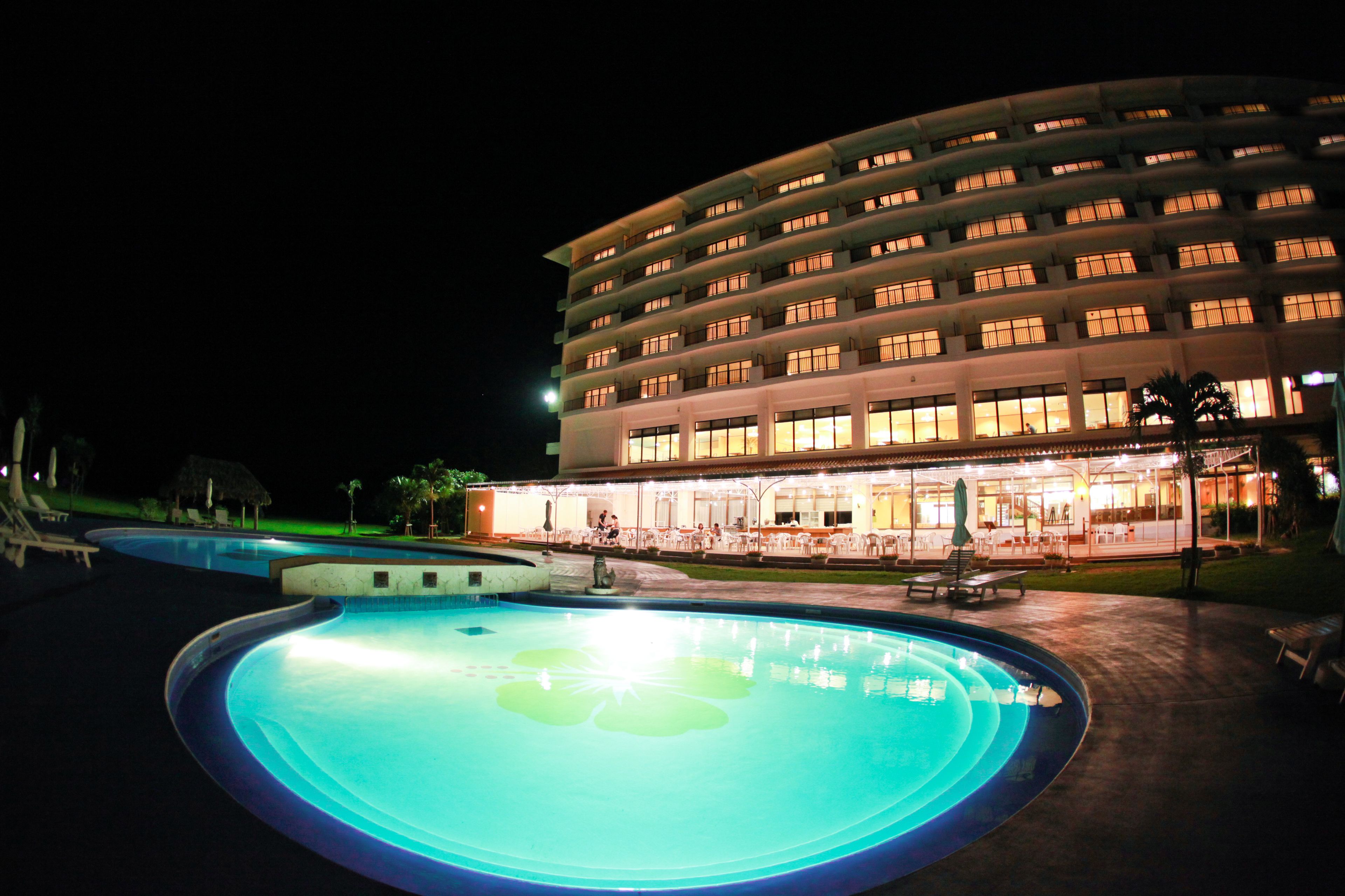 A hotel with a swimming pool and outdoor seating area.