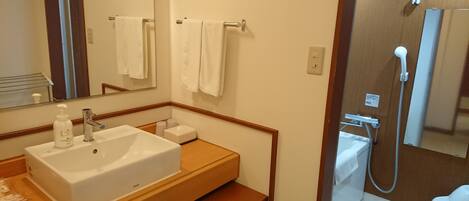A bathroom with a white sink, mirror, and towel rack.