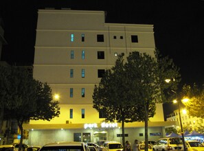 A multi-story hotel with a flat facade, several windows, and a sign reading "Park Hotel".