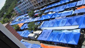 A large outdoor market with numerous blue and orange tents. - Park Hotel (Kota Kinabalu)
