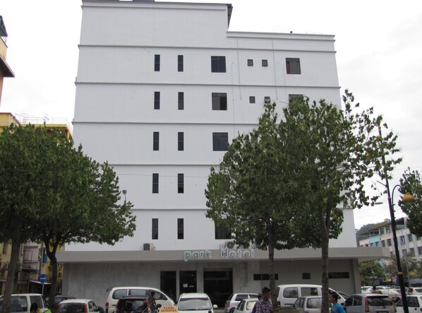 A multi-story building with a flat facade, several windows, and a sign reading "park hotel".