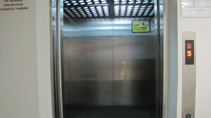 An elevator interior with a warning sign for 24-hour CCTV surveillance. - Park Hotel (Kota Kinabalu)
