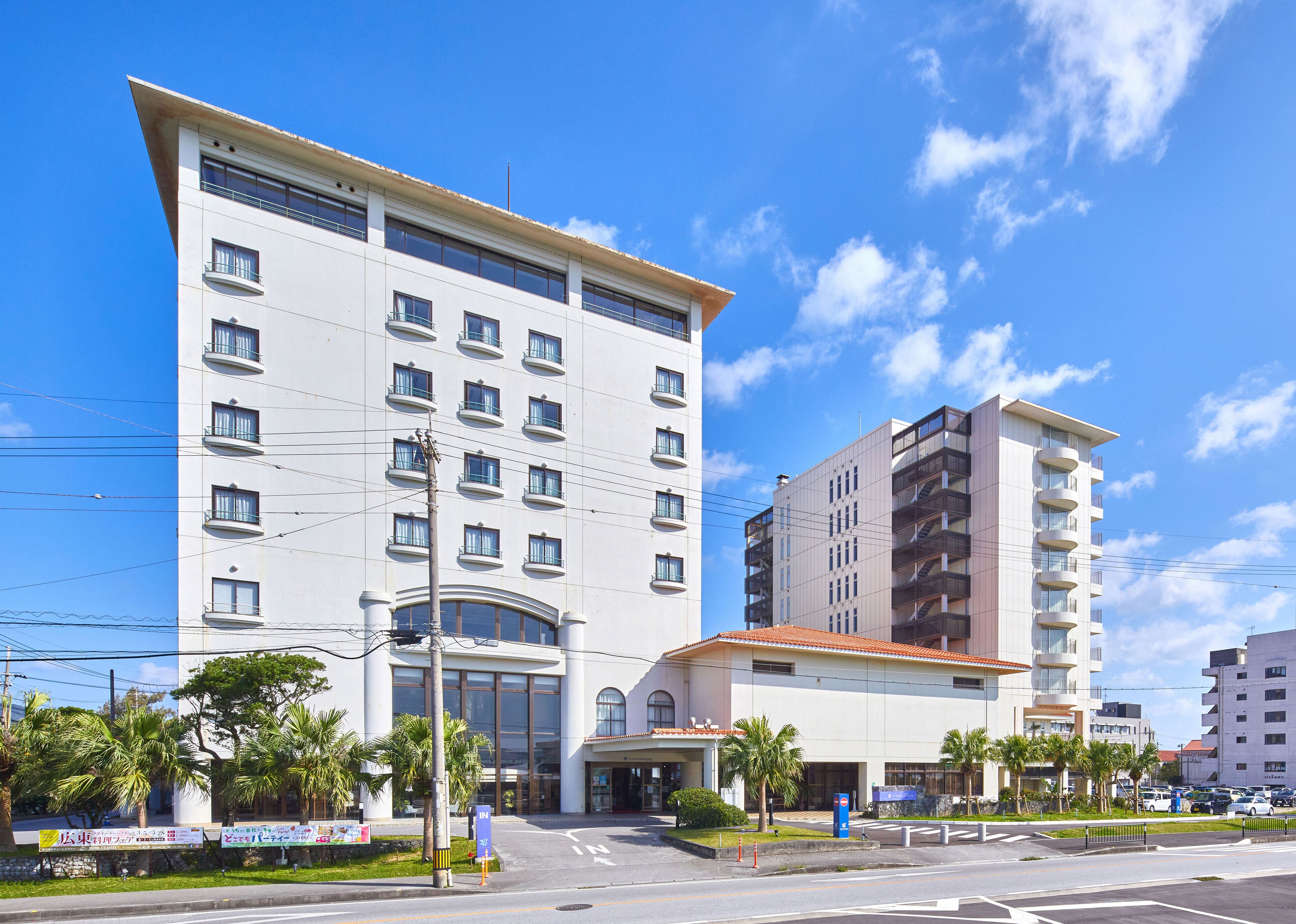A multi-story hotel with a modern facade, large windows, and a prominent entrance.