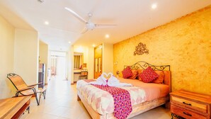 A spacious bedroom with a large bed, a wooden nightstand, a desk, and a chair. - High Lords Residence (Pattaya)