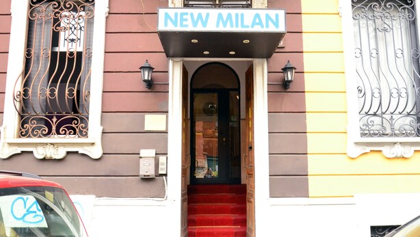 A building entrance with a sign reading "NEW MILAN" above the door. - Hotel New Milan (Milan)
