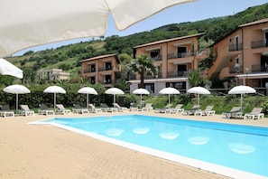 Piscine extérieure, parasols, chaises longues