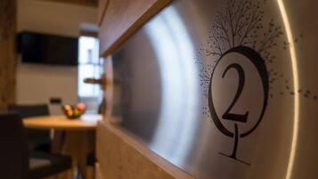 A wall with a number '2' and a tree design, indicating a room or section number.