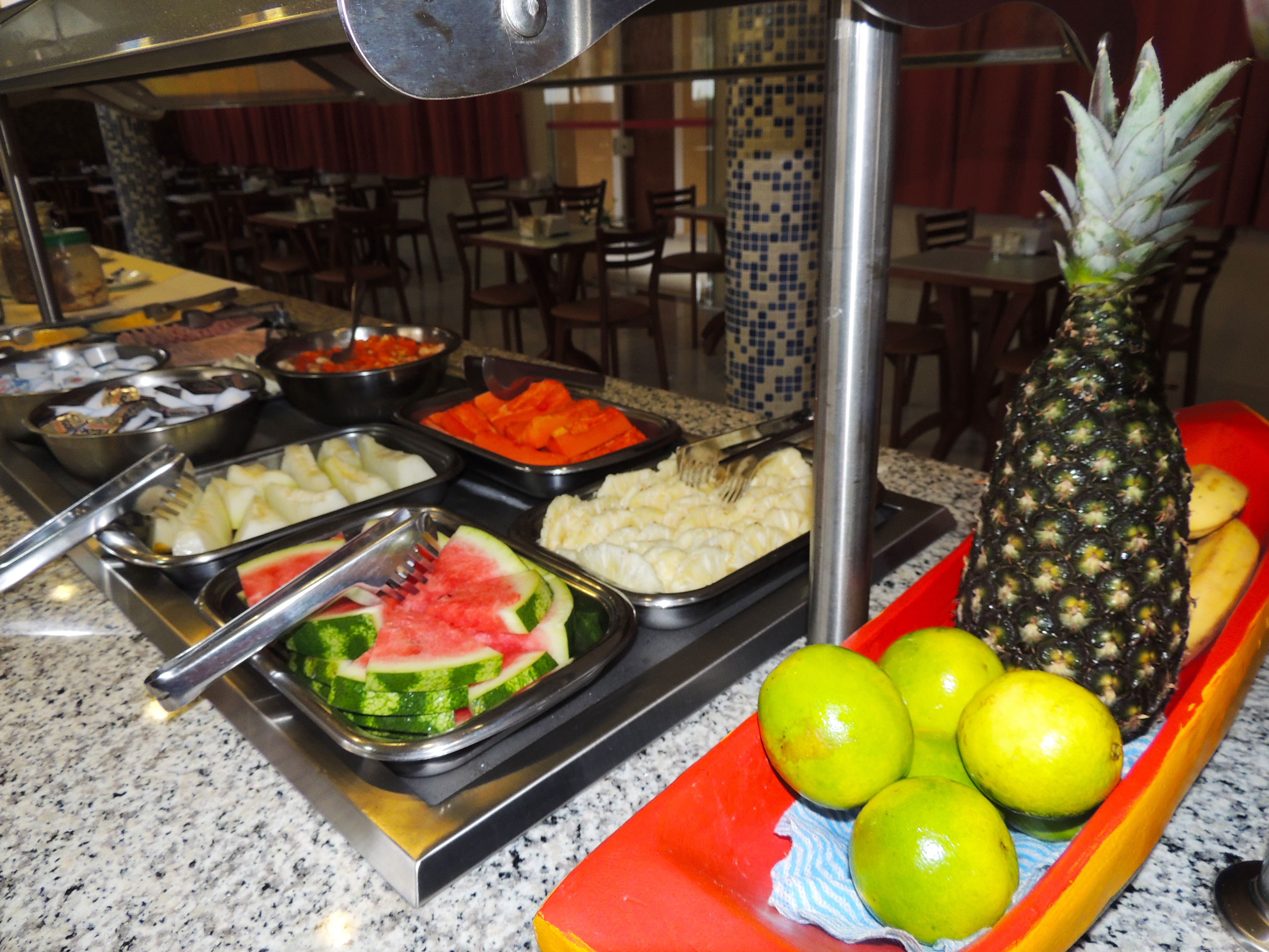 A buffet with various food items including fruits, vegetables, and a pineapple.