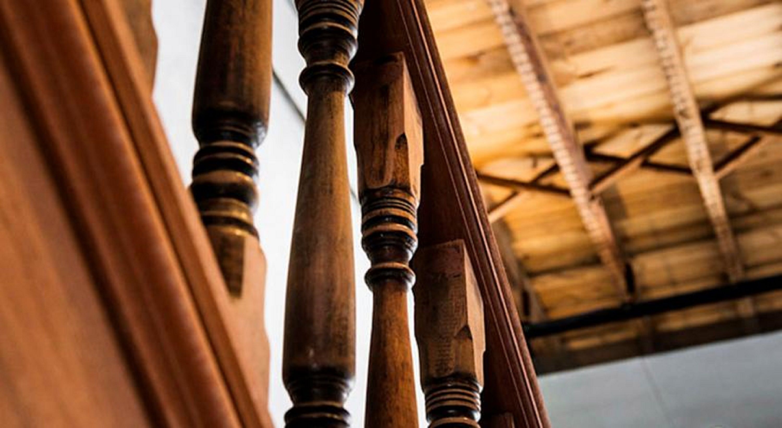 A close-up of wooden balusters on a staircase.