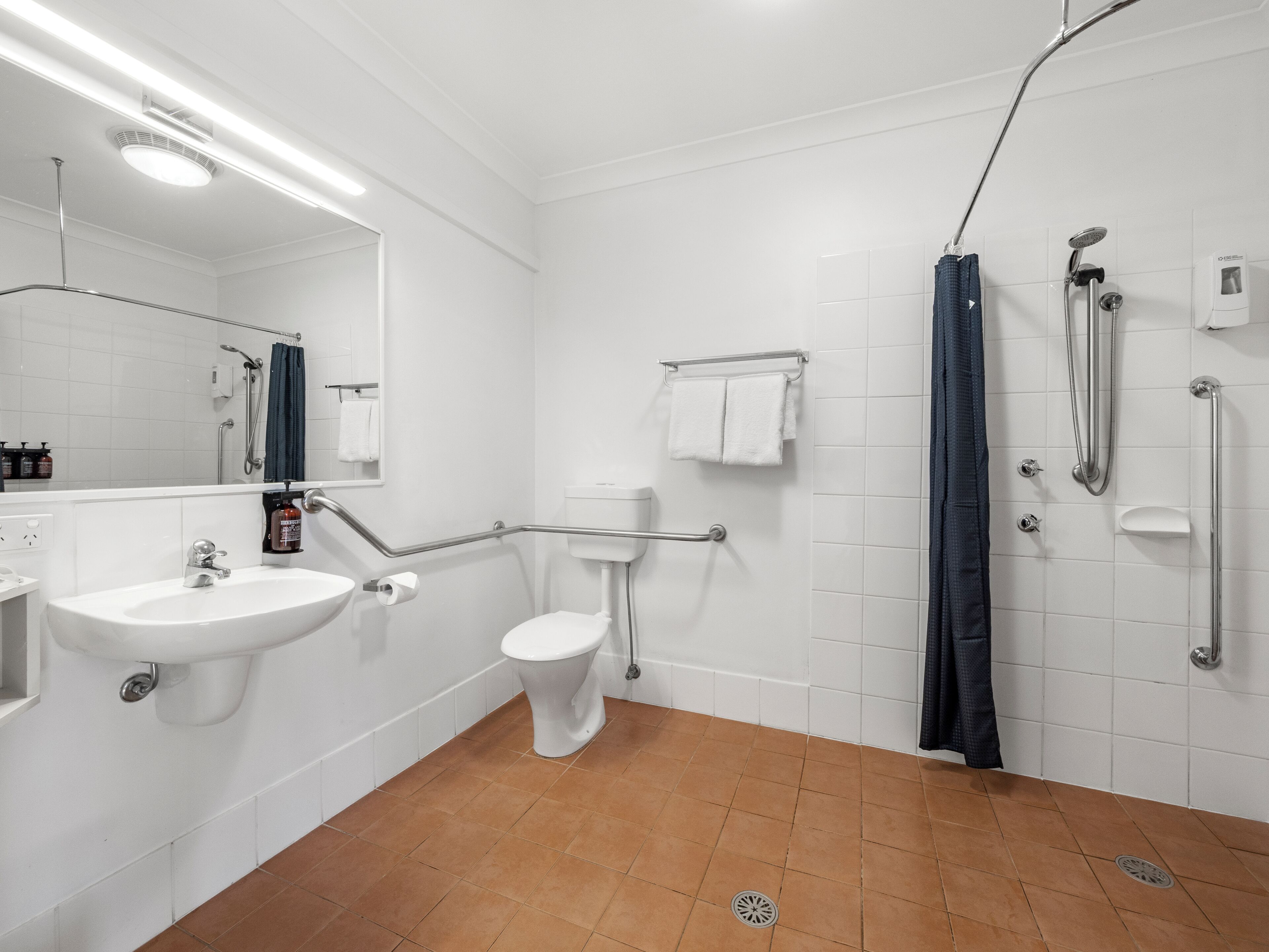 A bathroom with a sink, toilet, and shower.