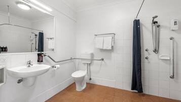 A bathroom with a sink, toilet, and shower.