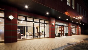 A hotel entrance with a check-in counter, seating area, and a sign indicating the hotel's name. - Hotel Hokke Club Kagoshima (Kagoshima)