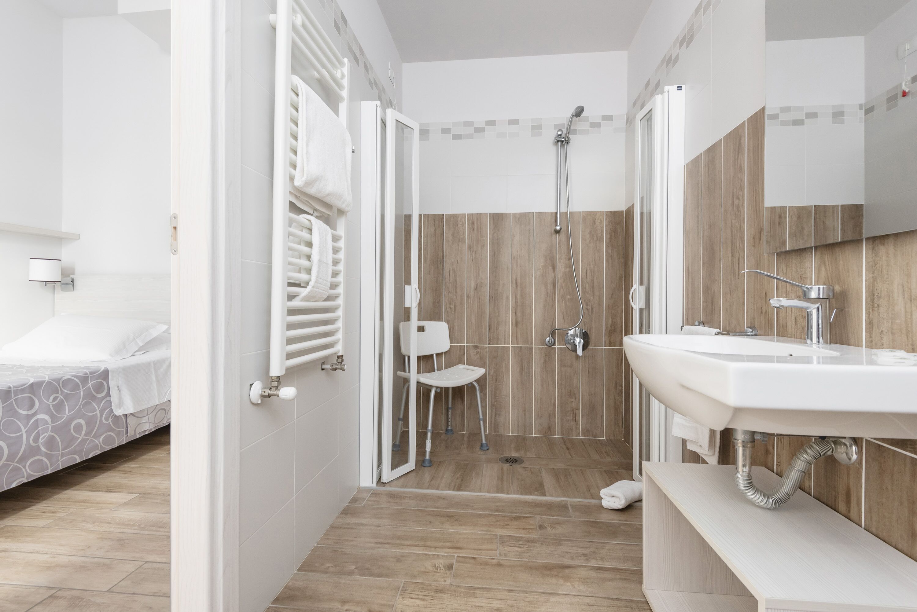 A modern bathroom with a shower, toilet, and sink.