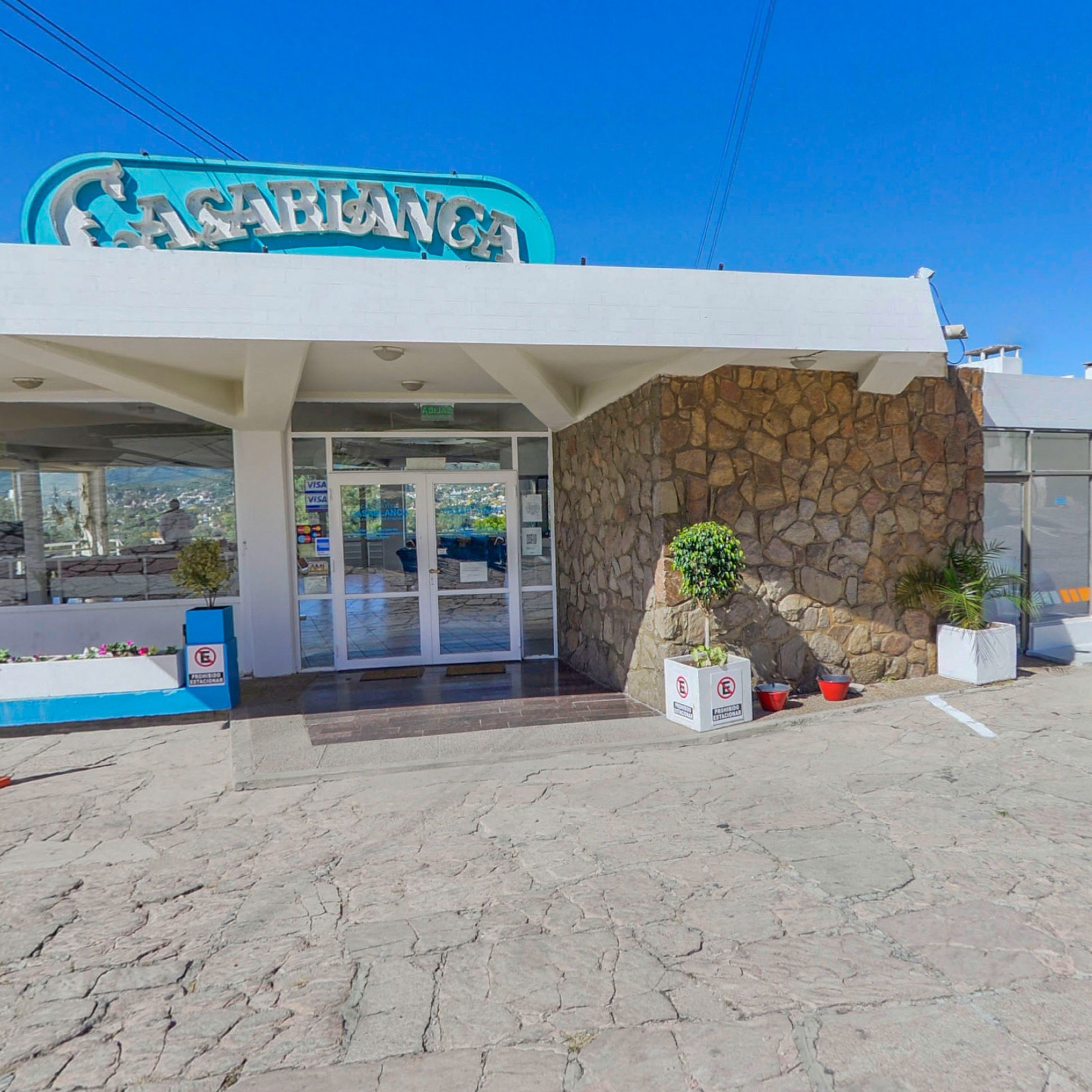 A building with a stone facade and a blue sign that reads "CASABLANCA".