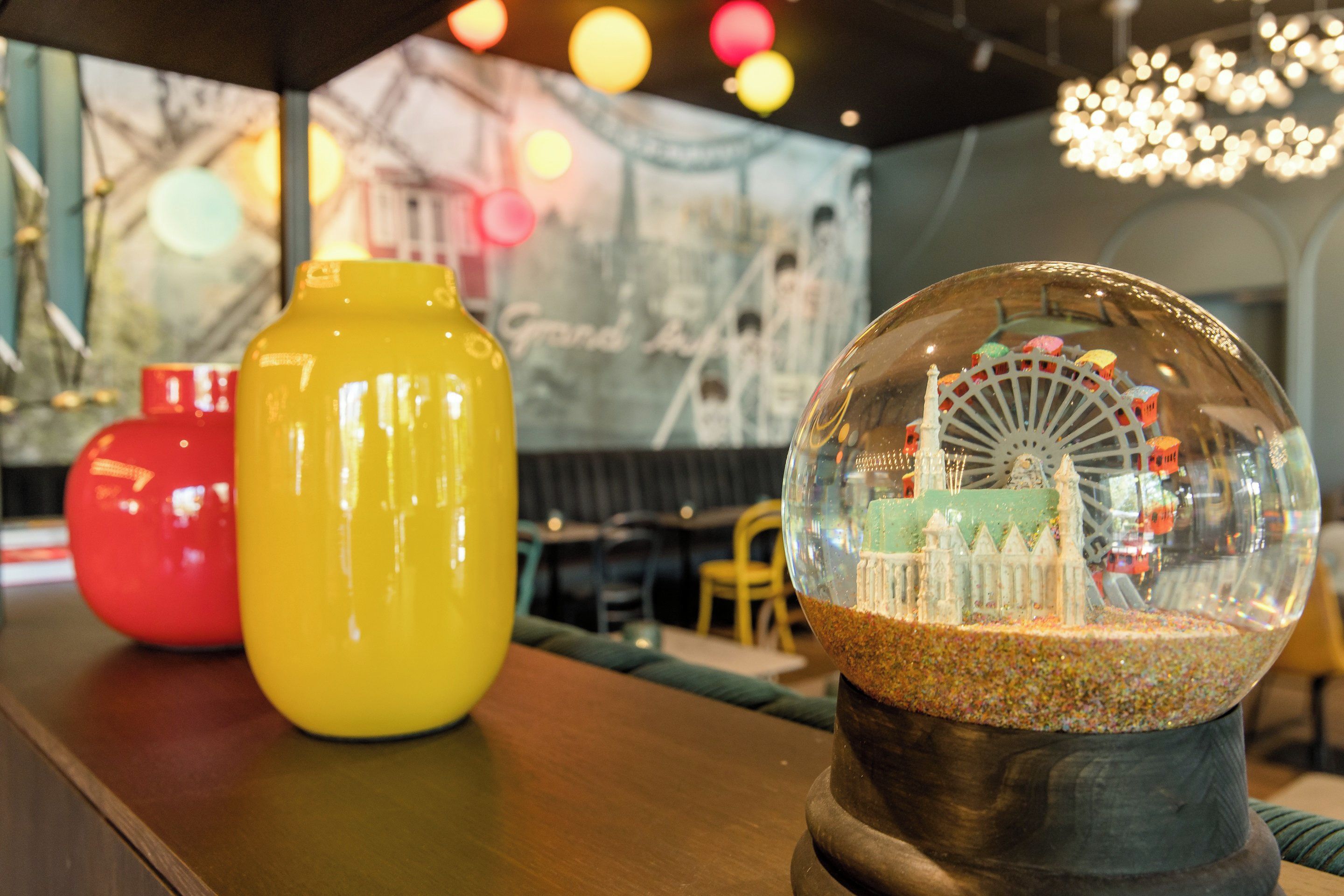 A bar area with a snow globe decoration and a mural in the background.