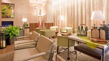 Vestíbulo de hotel con asientos, un mostrador de recepción y una zona de bar.