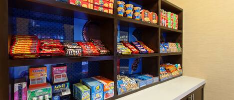 A snack display with various packaged foods and beverages.