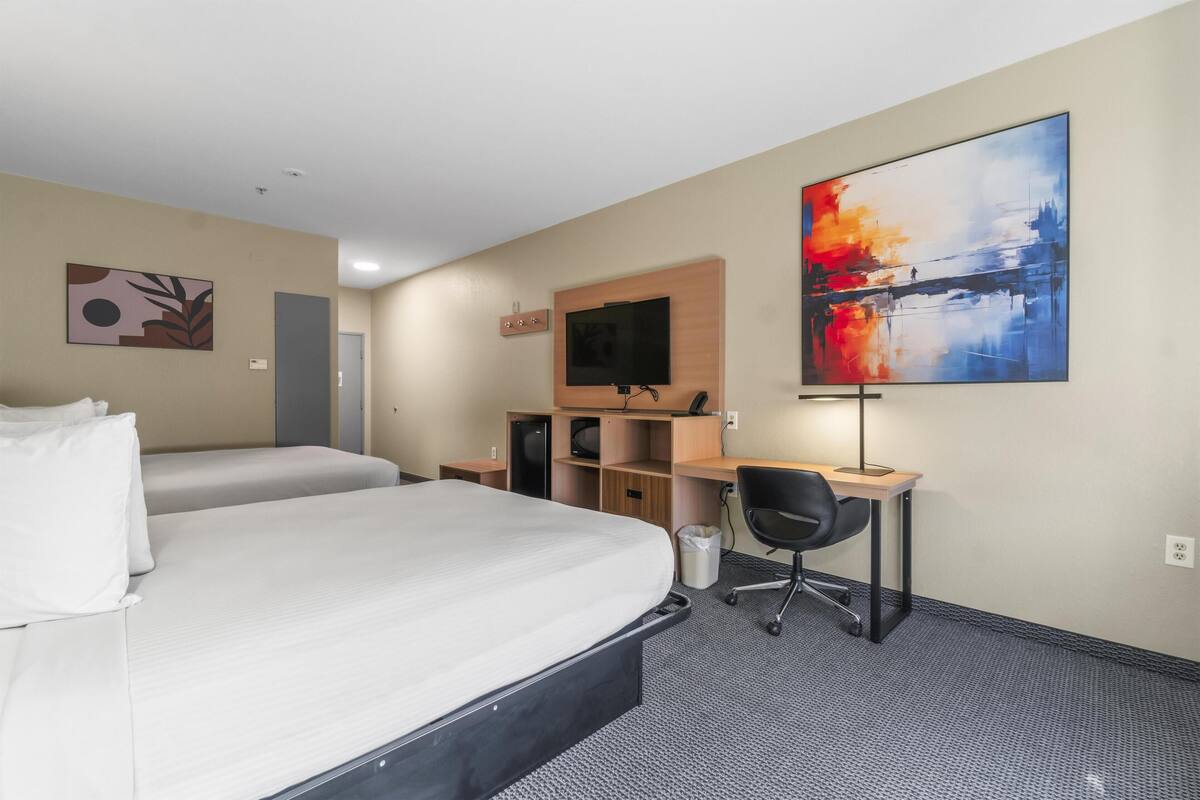 Premium bedding, desk, laptop workspace, blackout drapes