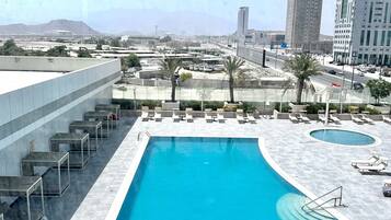 Outdoor pool, free pool cabanas, pool umbrellas