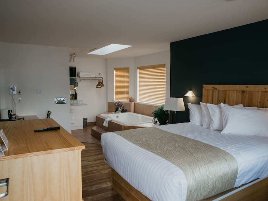 Suíte, 1 cama Queen, banheira de hidromassagem | Escrivaninha, ferros/tábuas de passar roupa, Wi-Fi de cortesia