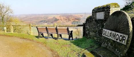 A bench area with a stone sign reading "GILLAMOOR" and a view of the countryside.