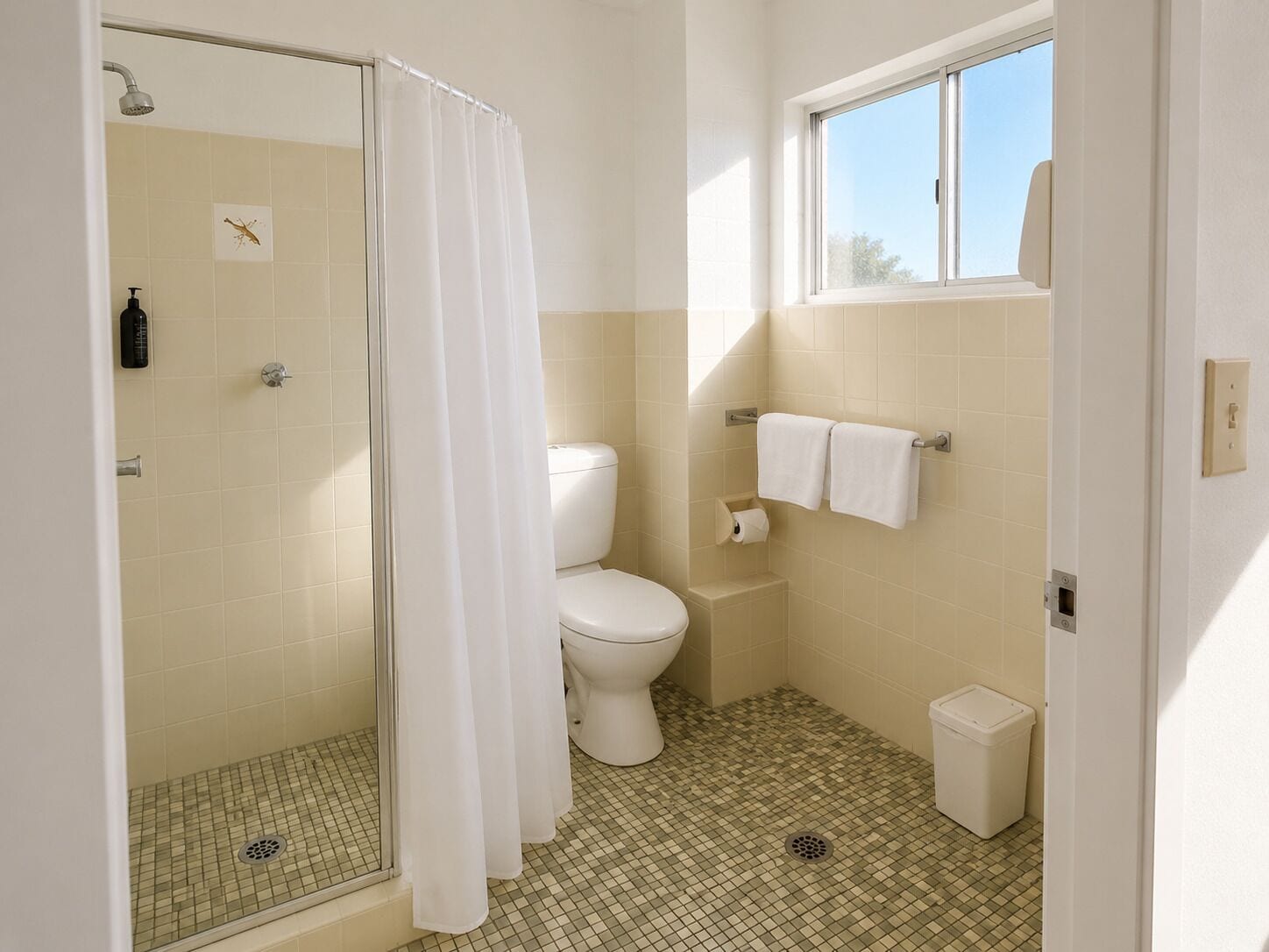 A bathroom with a shower, toilet, and a window.